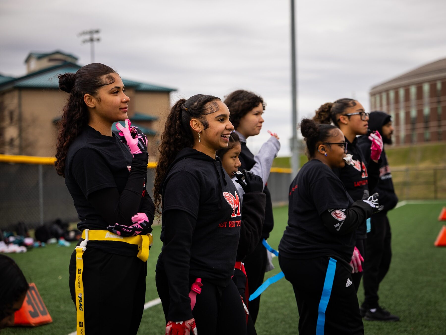 McCaskey girls flag football athletes watching from the sideline